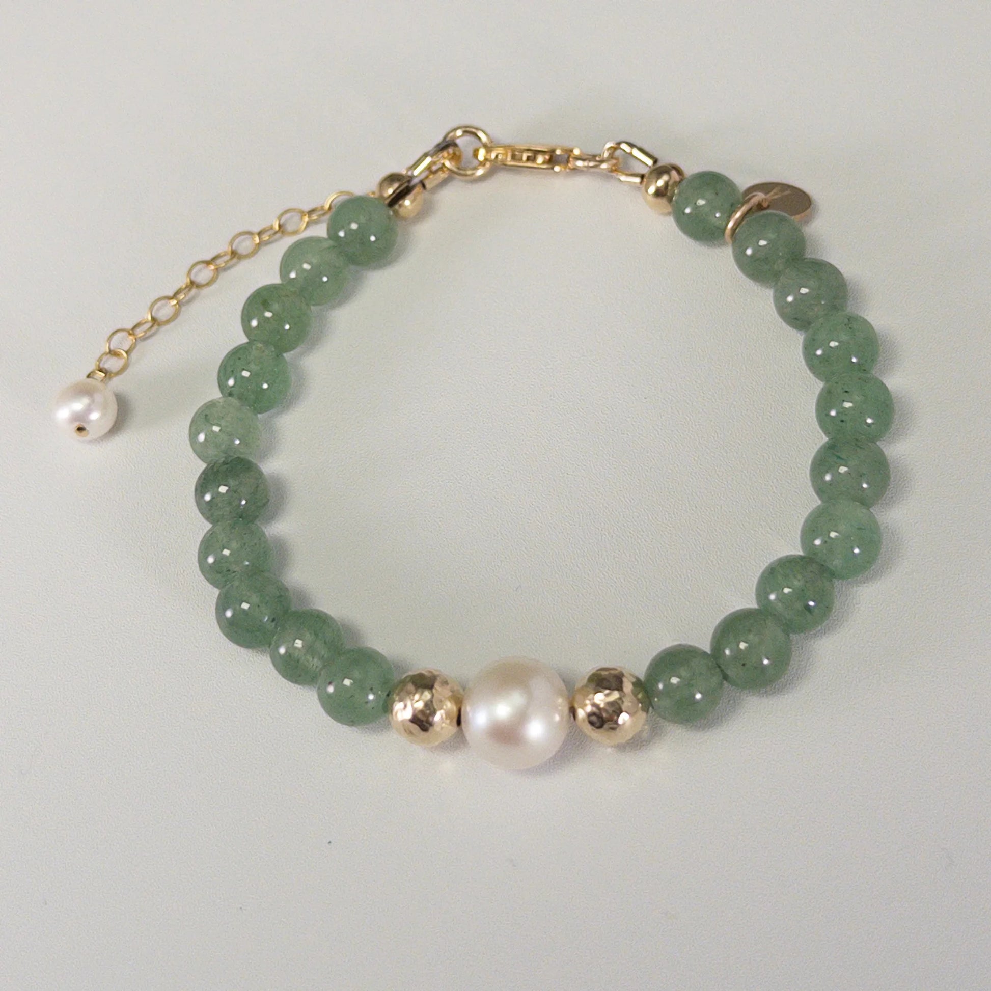 Green aventurine, pearl and initial gold bracelet featuring polished green gemstone beads, lustrous freshwater pearls and a personalised gold-filled stamped initial disc.