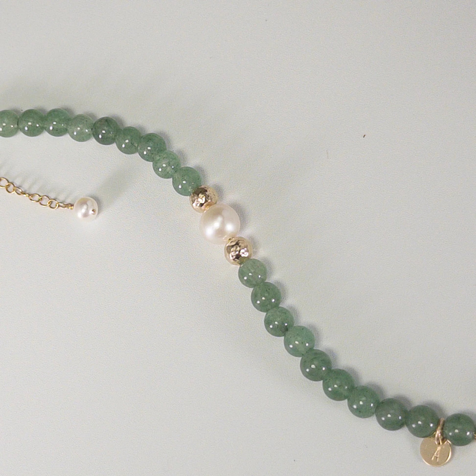 Green aventurine, pearl and initial gold bracelet featuring polished green gemstone beads, lustrous freshwater pearls and a personalised gold-filled stamped initial disc.
