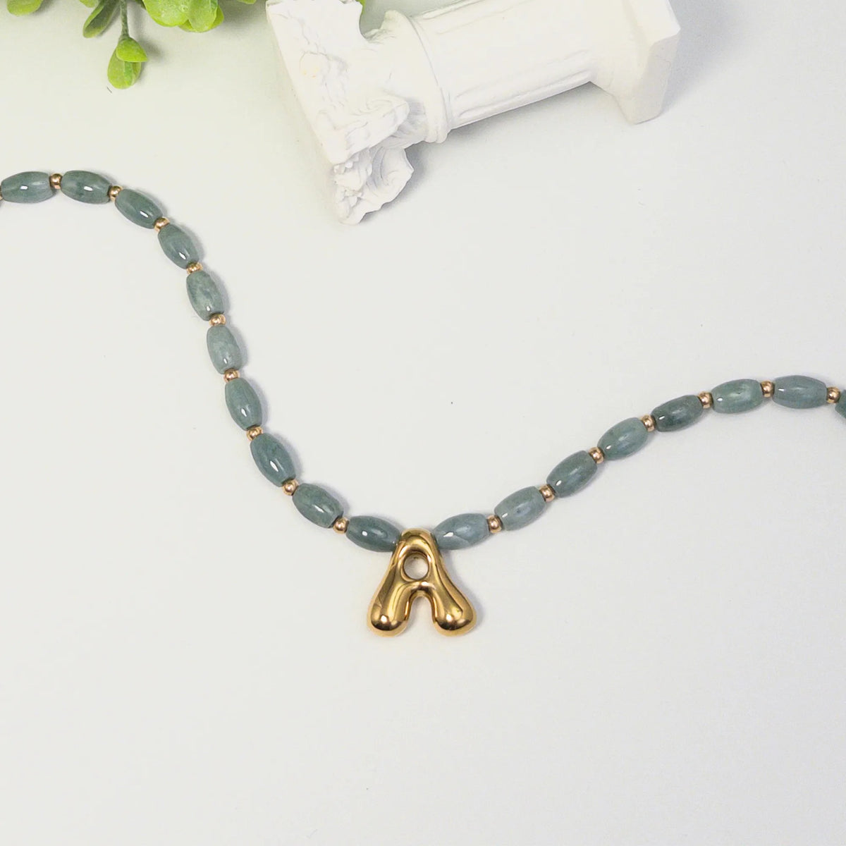 Guatemalan jade initial necklace with smooth barrel beads, 14K gold filled spacers and a bubble letter pendant