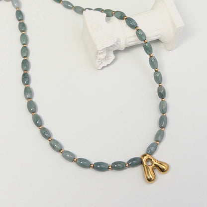 Guatemalan jade initial necklace with smooth barrel beads, 14K gold filled spacers and a bubble letter pendant