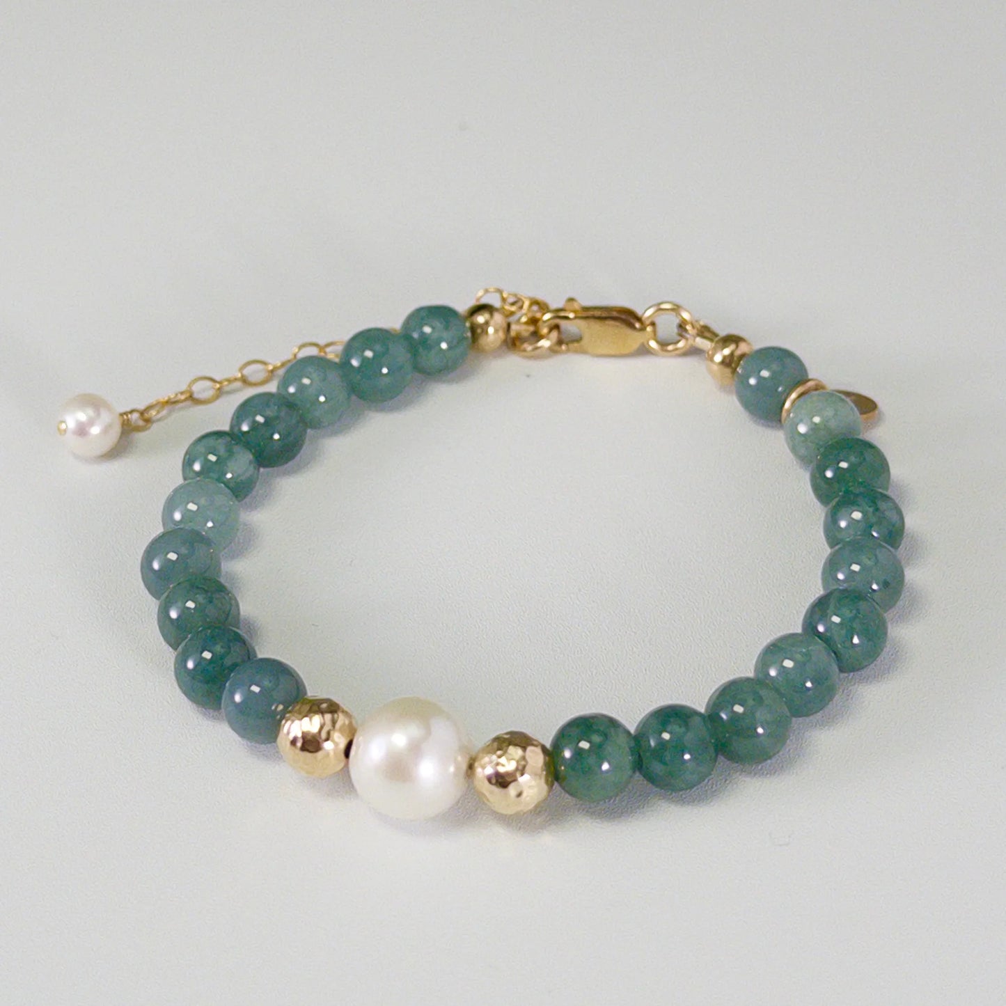 Guatemalan jade, pearl and initial gold bracelet featuring premium blue green Guatemalan jade beads, lustrous pearls and a personalised gold-filled stamped initial disc.
