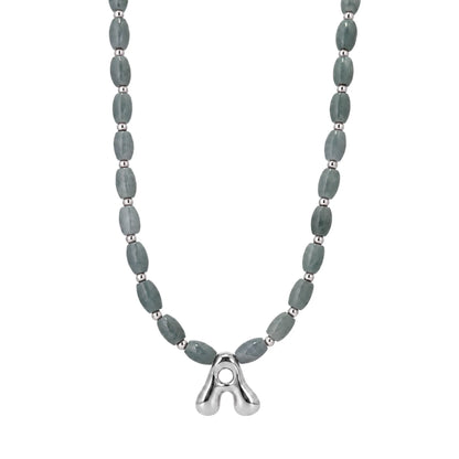 Guatemalan jade initial necklace with smooth barrel beads, sterling silver spacers and a bubble letter pendant