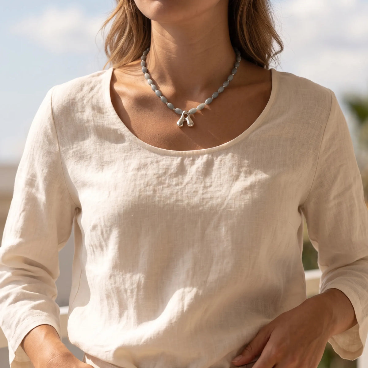 Guatemalan jade initial necklace with smooth barrel beads, sterling silver spacers and a bubble letter pendant