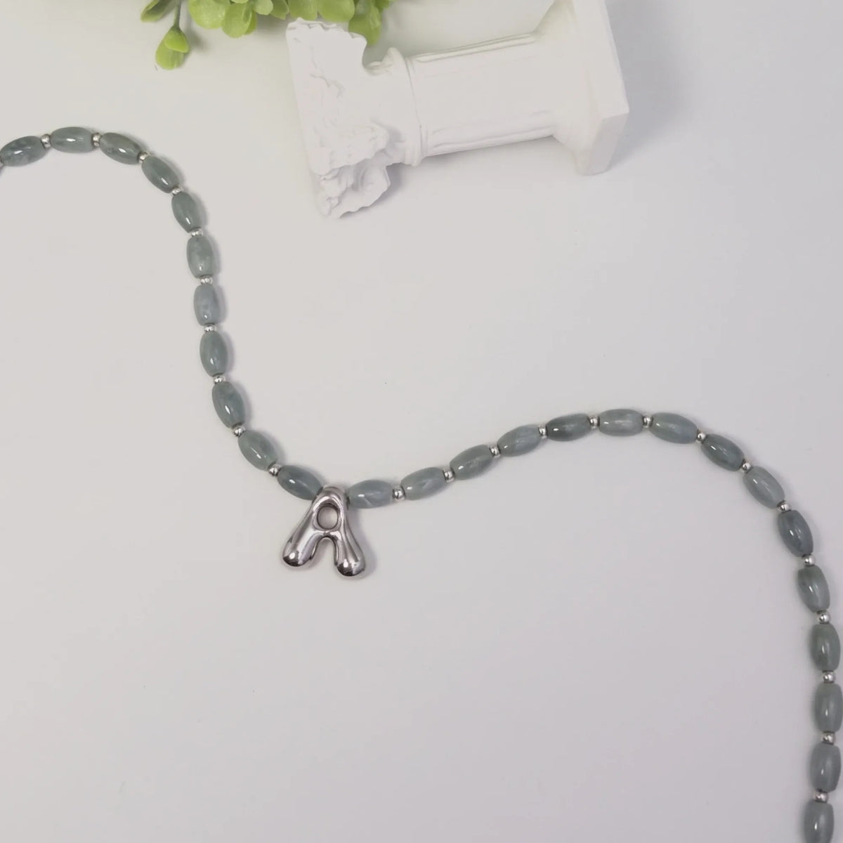 Guatemalan jade initial necklace with smooth barrel beads, sterling silver spacers and a bubble letter pendant