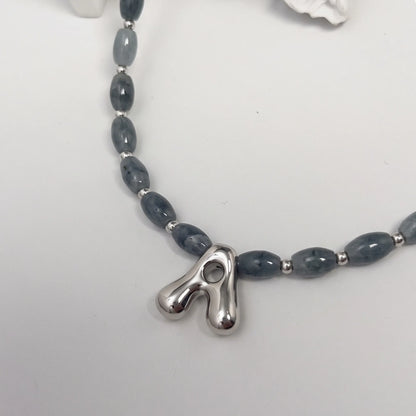 Guatemalan jade initial necklace with smooth barrel beads, sterling silver spacers and a bubble letter pendant