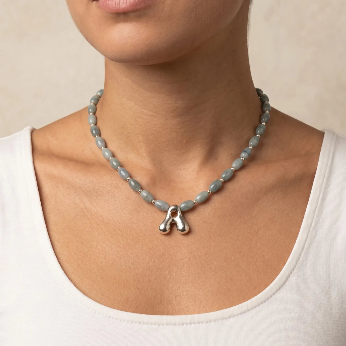 Guatemalan jade initial necklace with smooth barrel beads, sterling silver spacers and a bubble letter pendant
