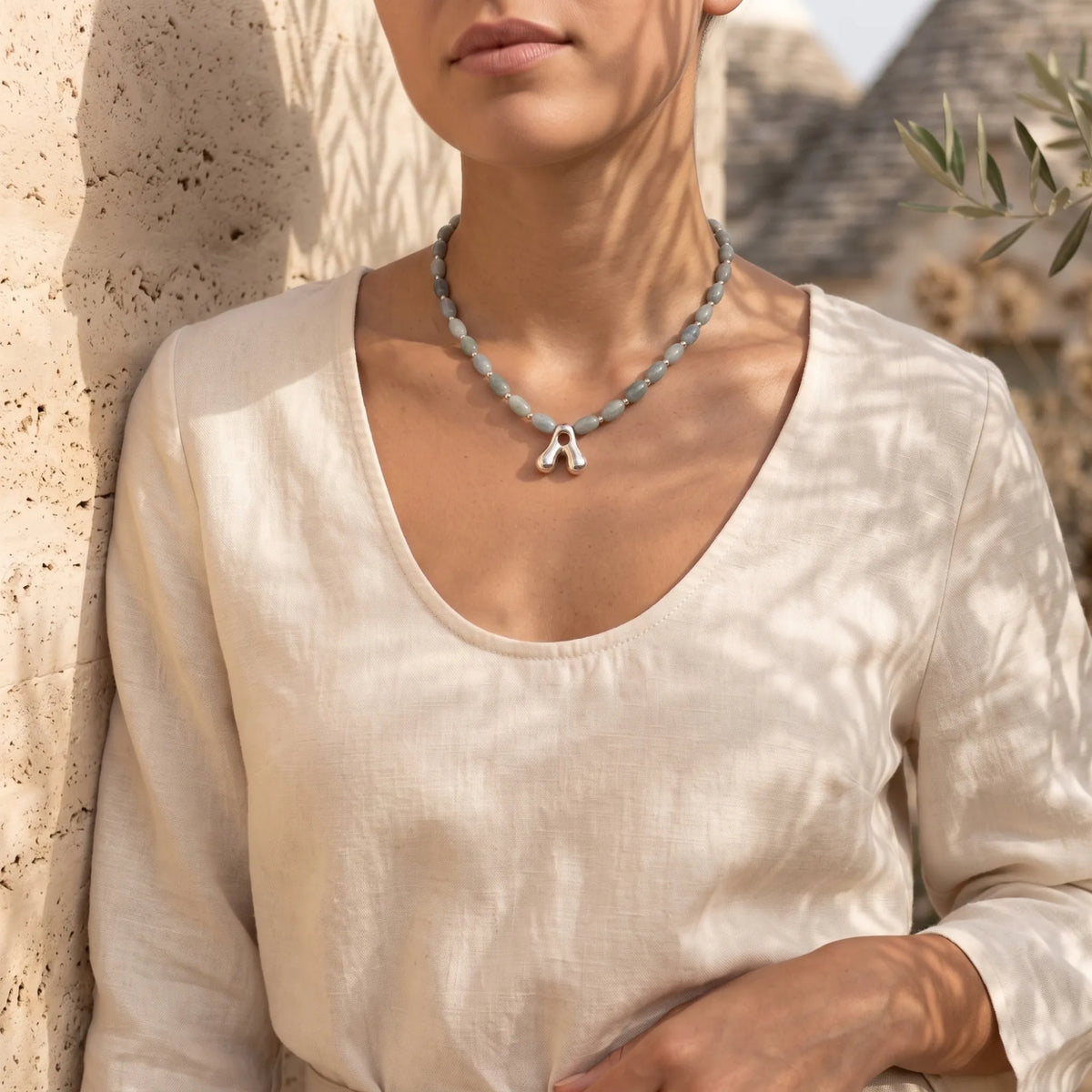 Guatemalan jade initial necklace with smooth barrel beads, sterling silver spacers and a bubble letter pendant