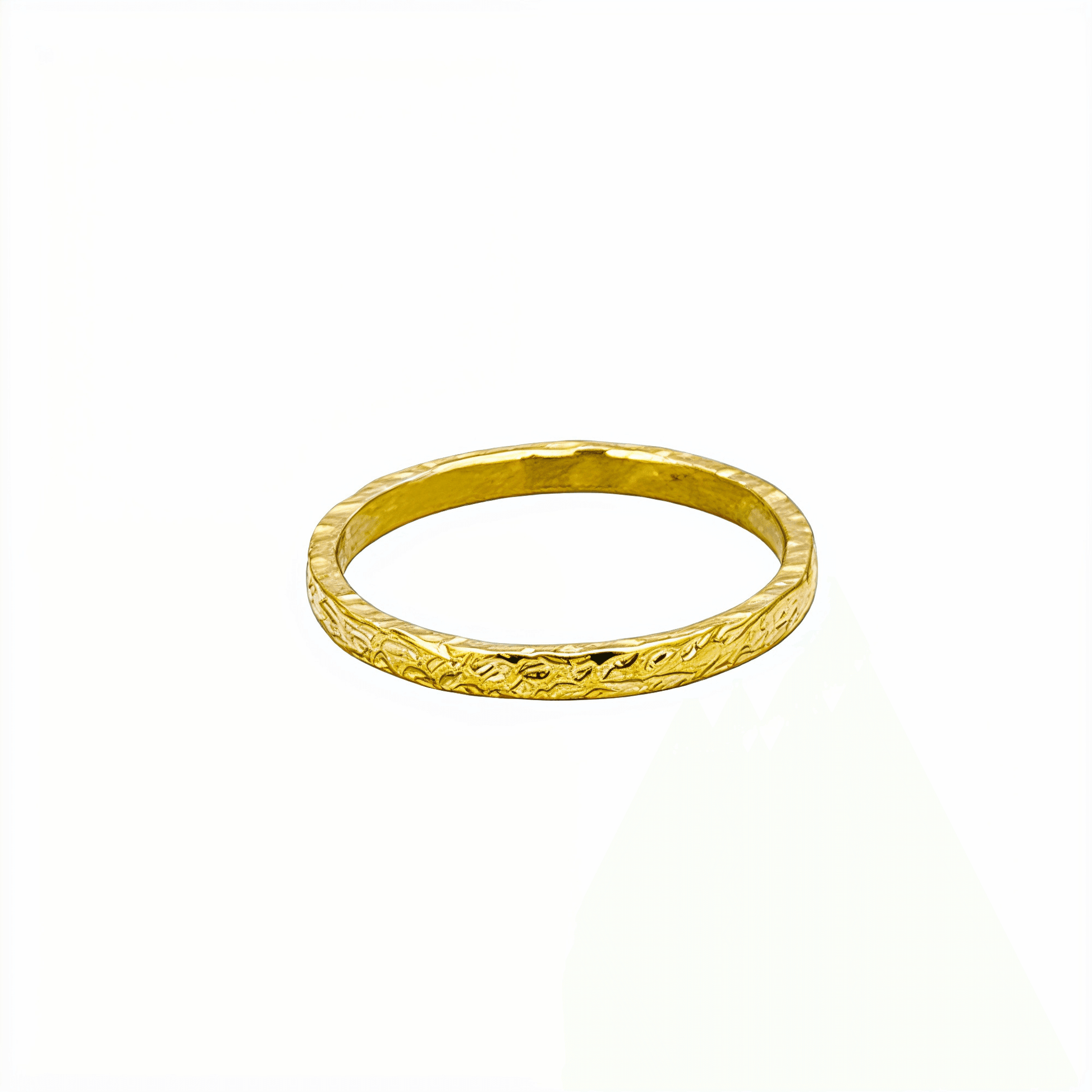 Minimal hammered slim gold ring with organic texture on a clean background.