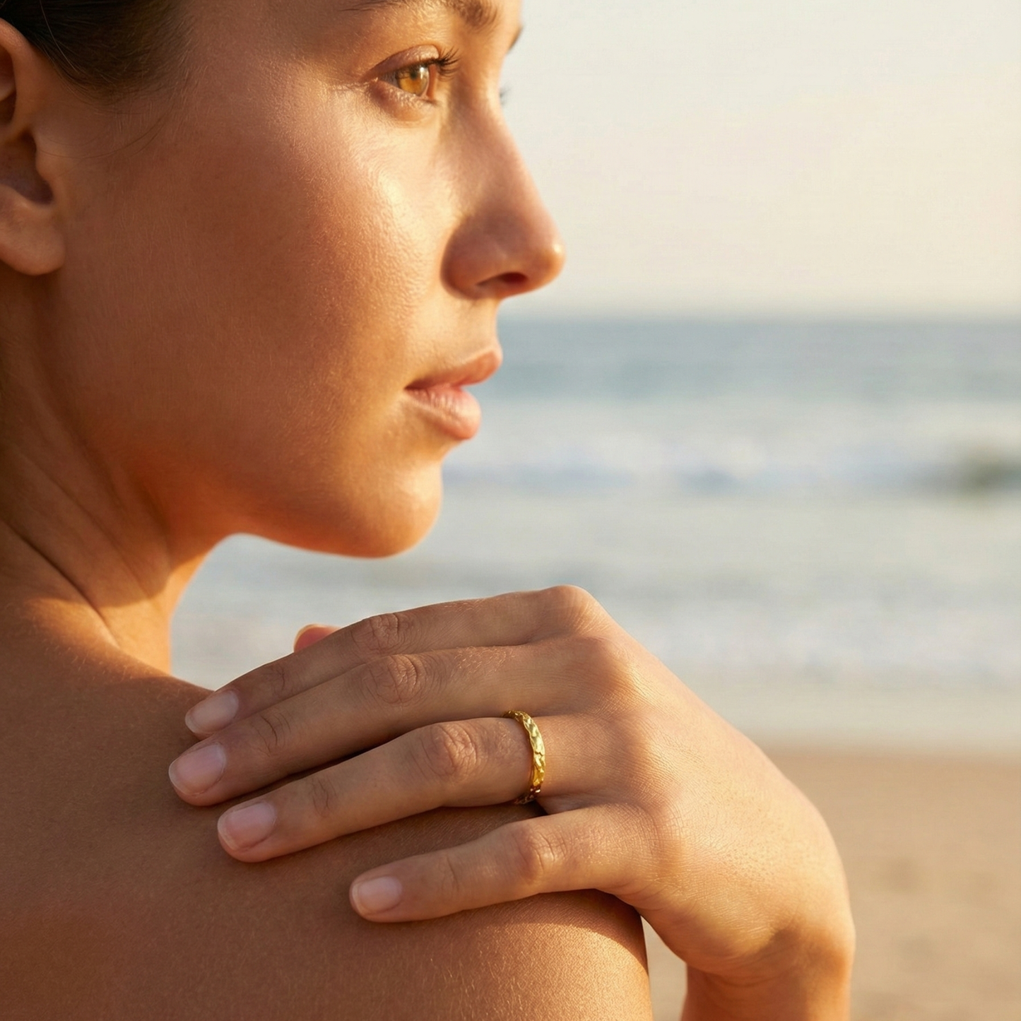 Minimal hammered slim gold ring with organic texture on a clean background.