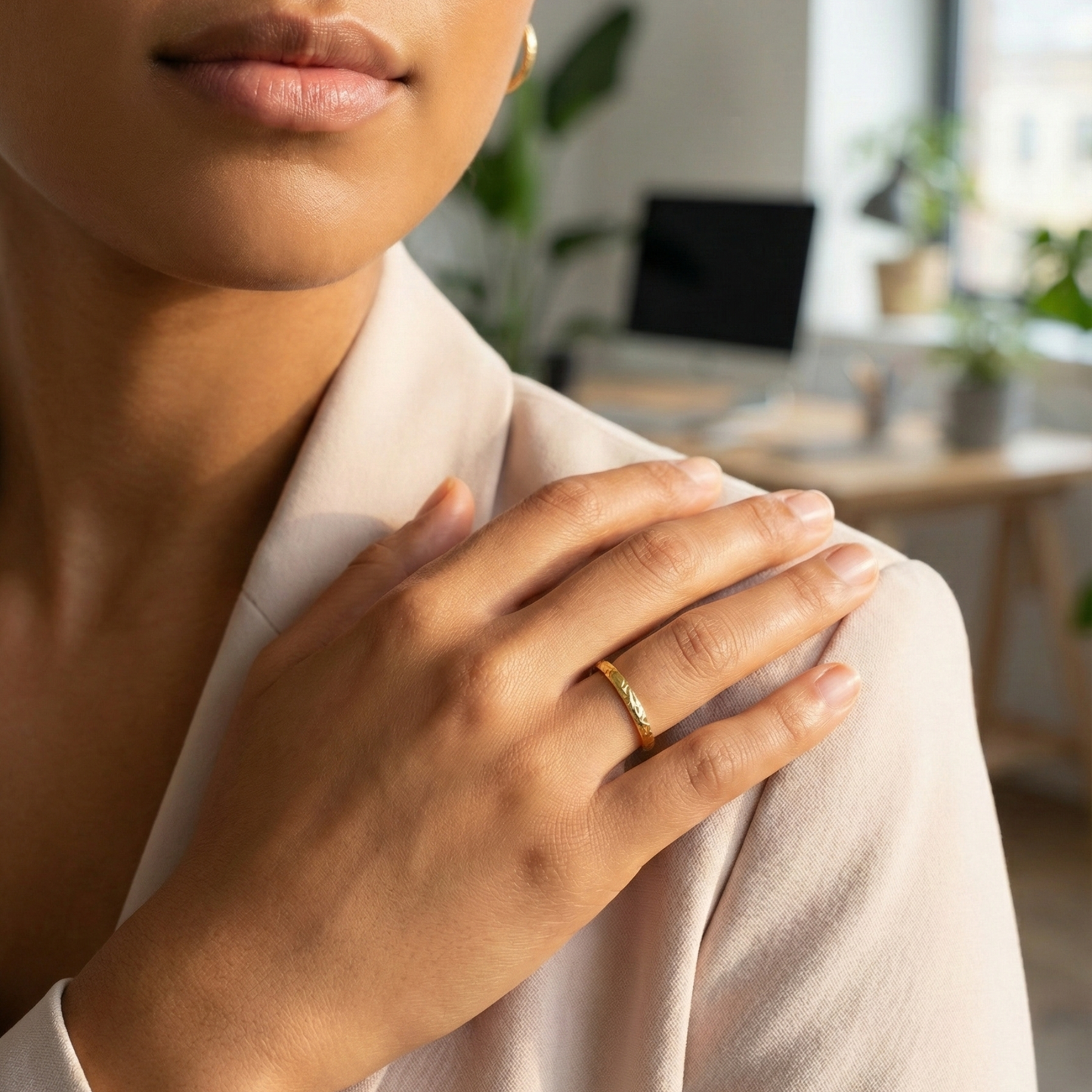 Minimal hammered slim gold ring with organic texture on a clean background.
