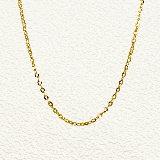 Hammered gold link chain with textured oval embossed links in waterproof stainless steel.