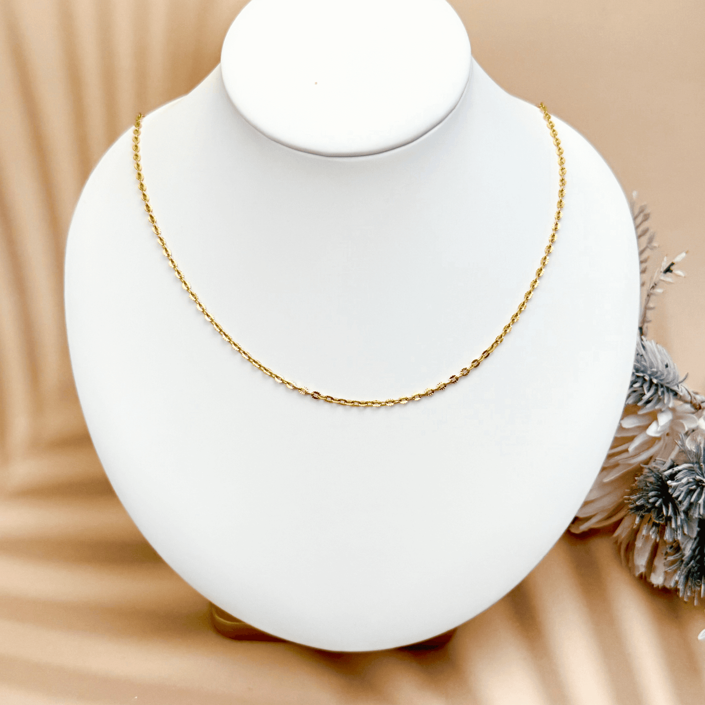 Hammered gold link chain with textured oval embossed links in waterproof stainless steel.