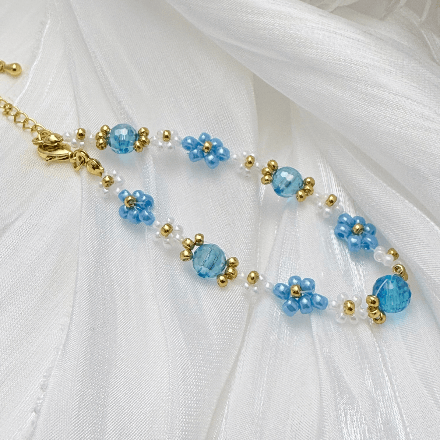 Handmade blue daisy flower beaded bracelet with Japanese glass beads and gold accents, available in gold or silver finish