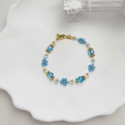 Handmade blue daisy flower beaded bracelet with Japanese glass beads and gold accents, available in gold or silver finish