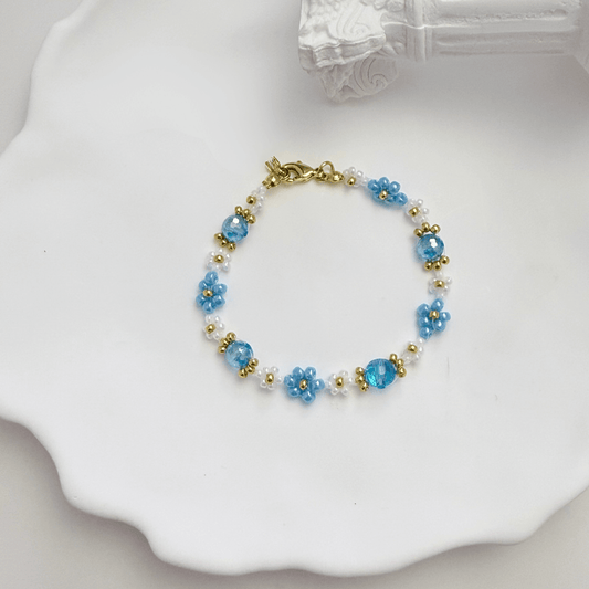Handmade blue daisy flower beaded bracelet with Japanese glass beads and gold accents, available in gold or silver finish