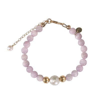 Kunzite, pearl and initial gold bracelet featuring translucent violet kunzite beads, lustrous freshwater pearls and a personalised gold-filled stamped initial disc.