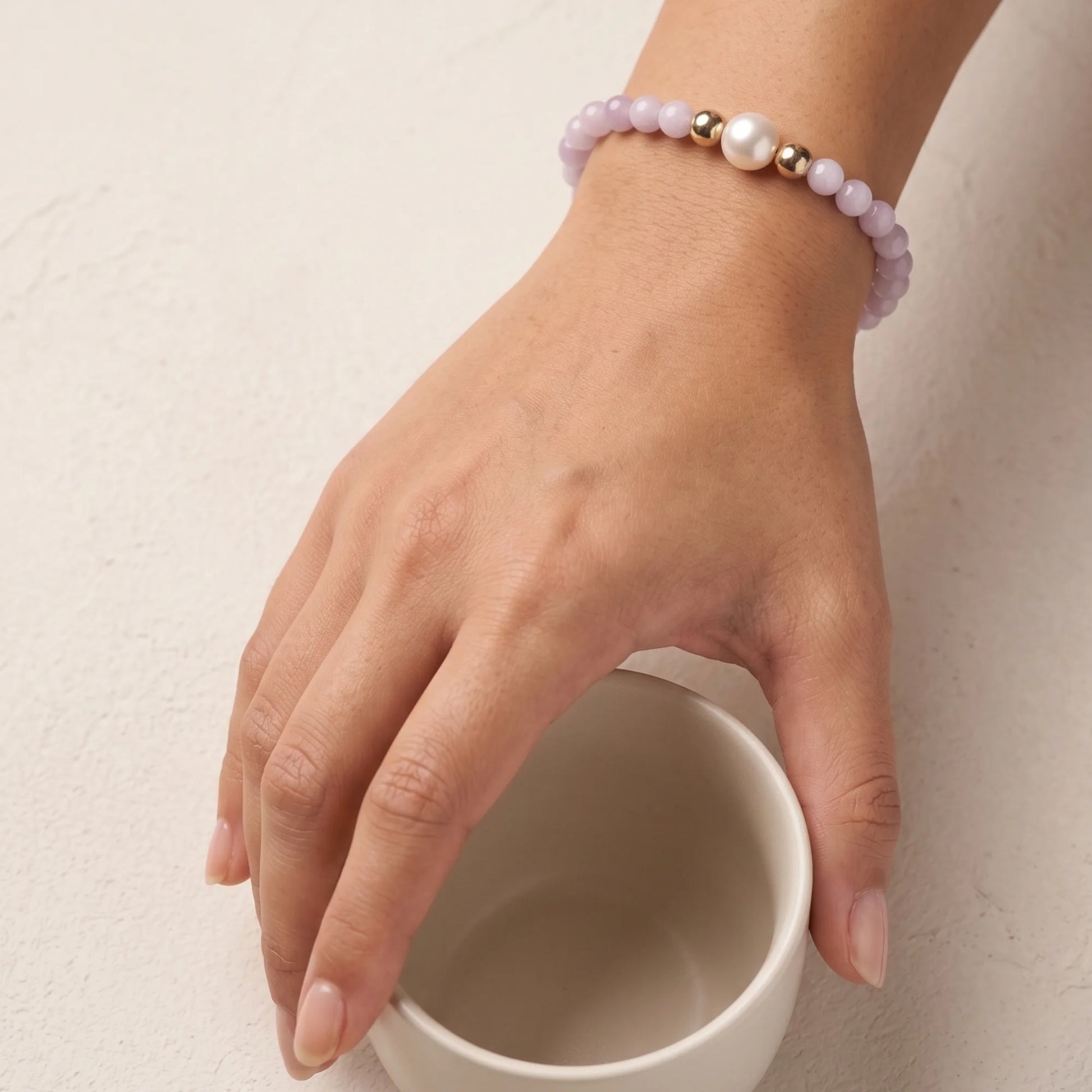 Kunzite, pearl and initial gold bracelet featuring translucent violet kunzite beads, lustrous freshwater pearls and a personalised gold-filled stamped initial disc.
