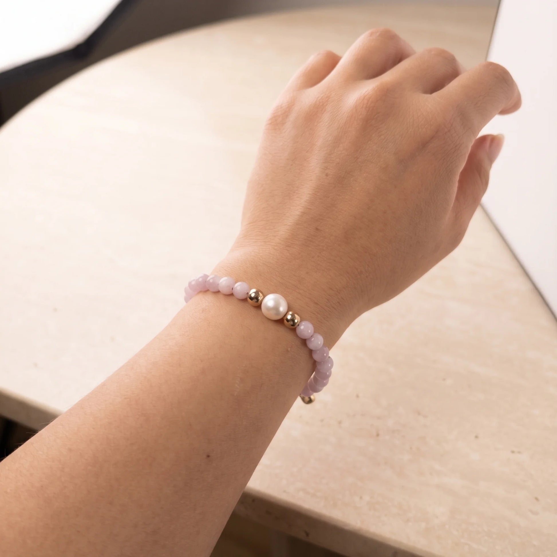 Kunzite, pearl and initial gold bracelet featuring translucent violet kunzite beads, lustrous freshwater pearls and a personalised gold-filled stamped initial disc.