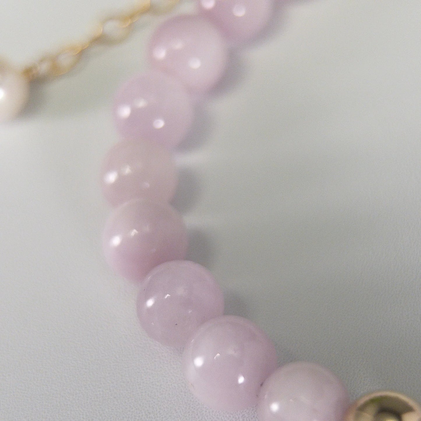 Kunzite, pearl and initial gold bracelet featuring translucent violet kunzite beads, lustrous freshwater pearls and a personalised gold-filled stamped initial disc.