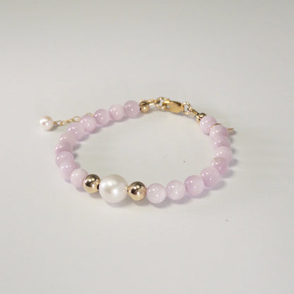 Kunzite, pearl and initial gold bracelet featuring translucent violet kunzite beads, lustrous freshwater pearls and a personalised gold-filled stamped initial disc.