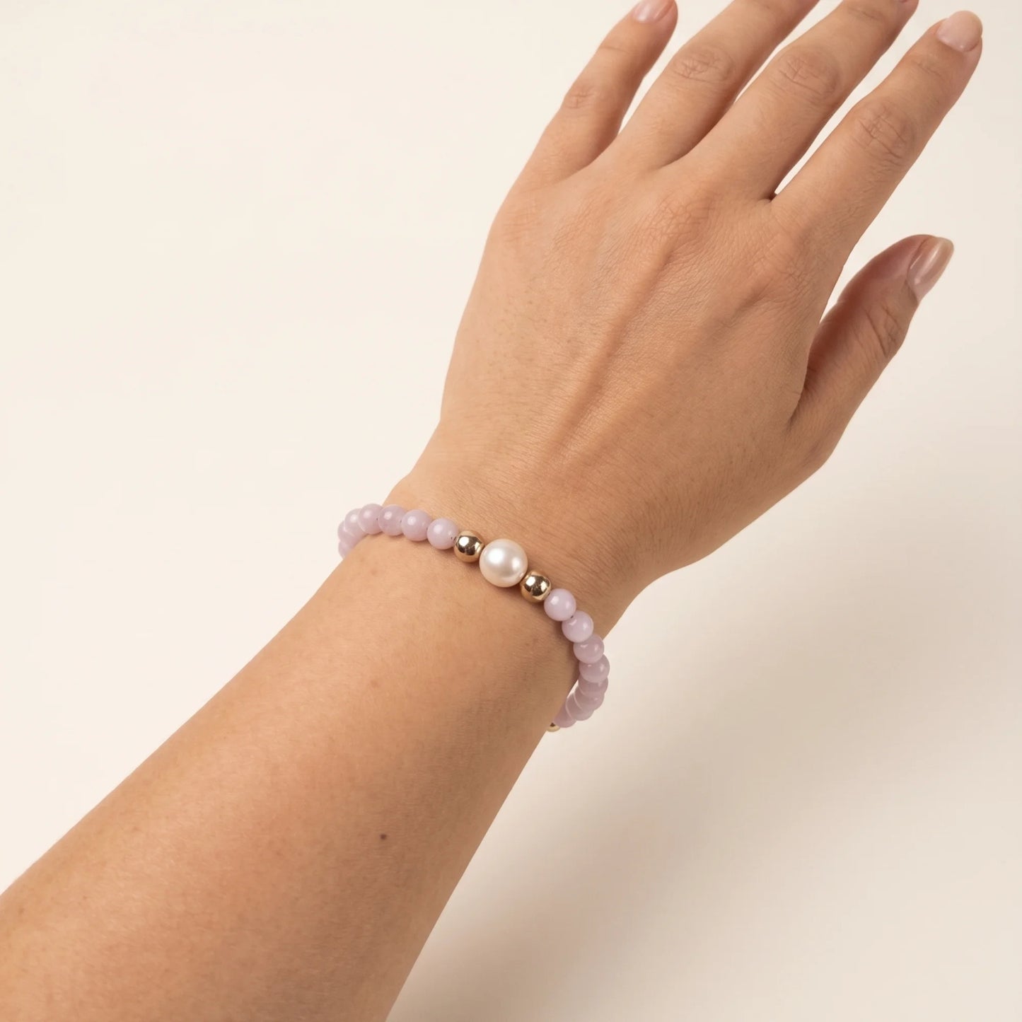 Kunzite, pearl and initial gold bracelet featuring translucent violet kunzite beads, lustrous freshwater pearls and a personalised gold-filled stamped initial disc.
