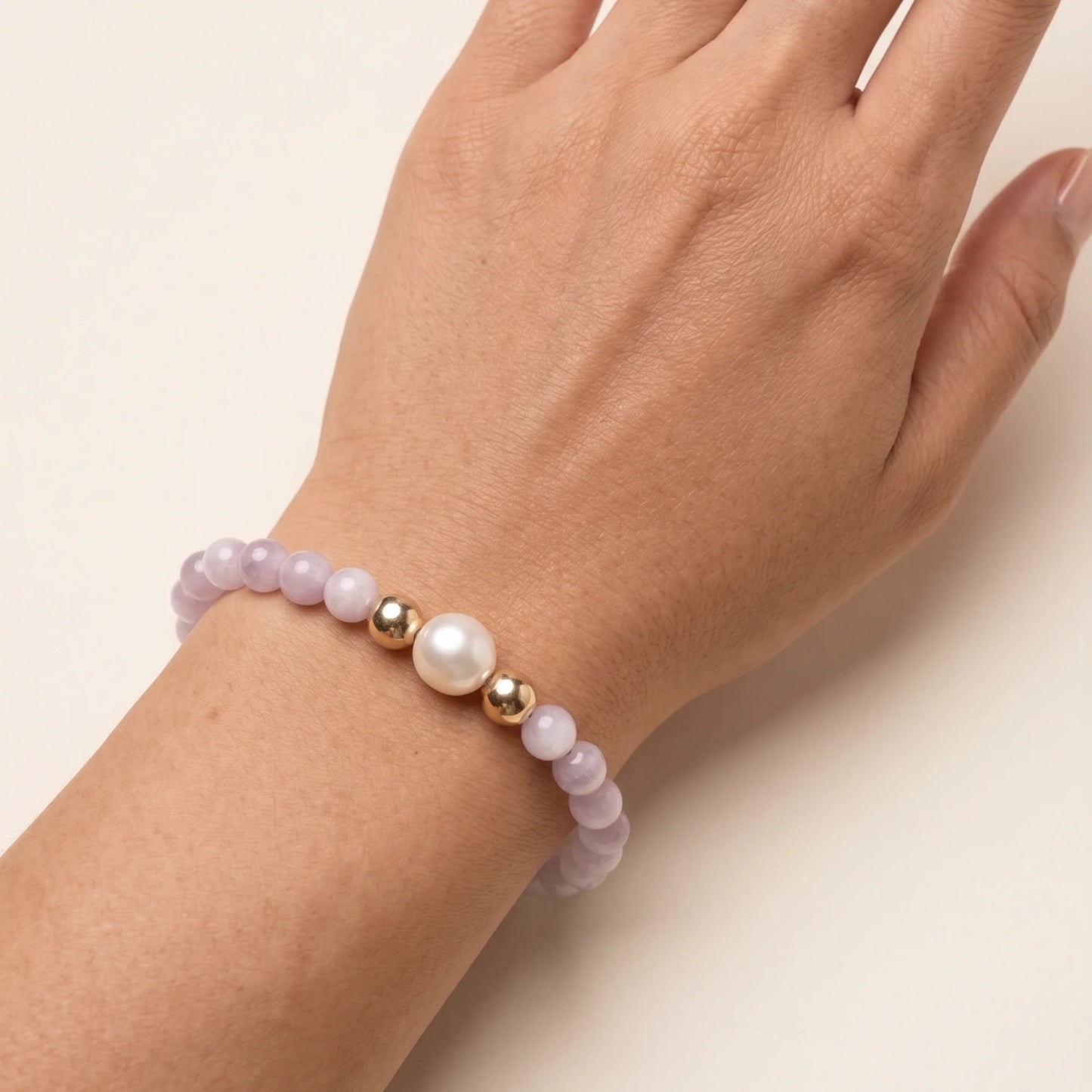 Kunzite, pearl and initial gold bracelet featuring translucent violet kunzite beads, lustrous freshwater pearls and a personalised gold-filled stamped initial disc.