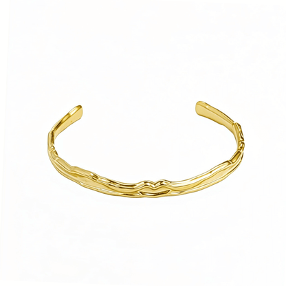 Gold textured cuff bracelet with molten, organic design.