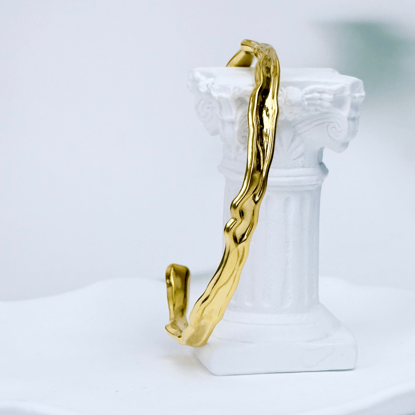 Gold textured cuff bracelet with molten, organic design.