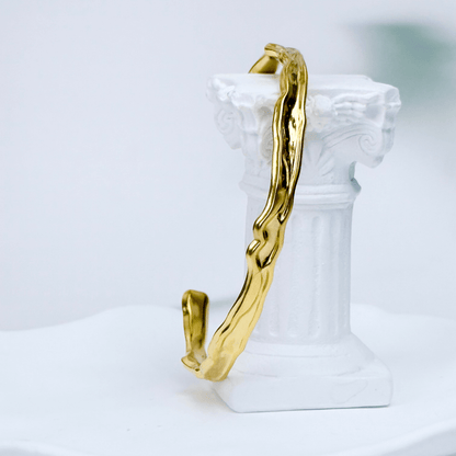 Gold textured cuff bracelet with molten, organic design.