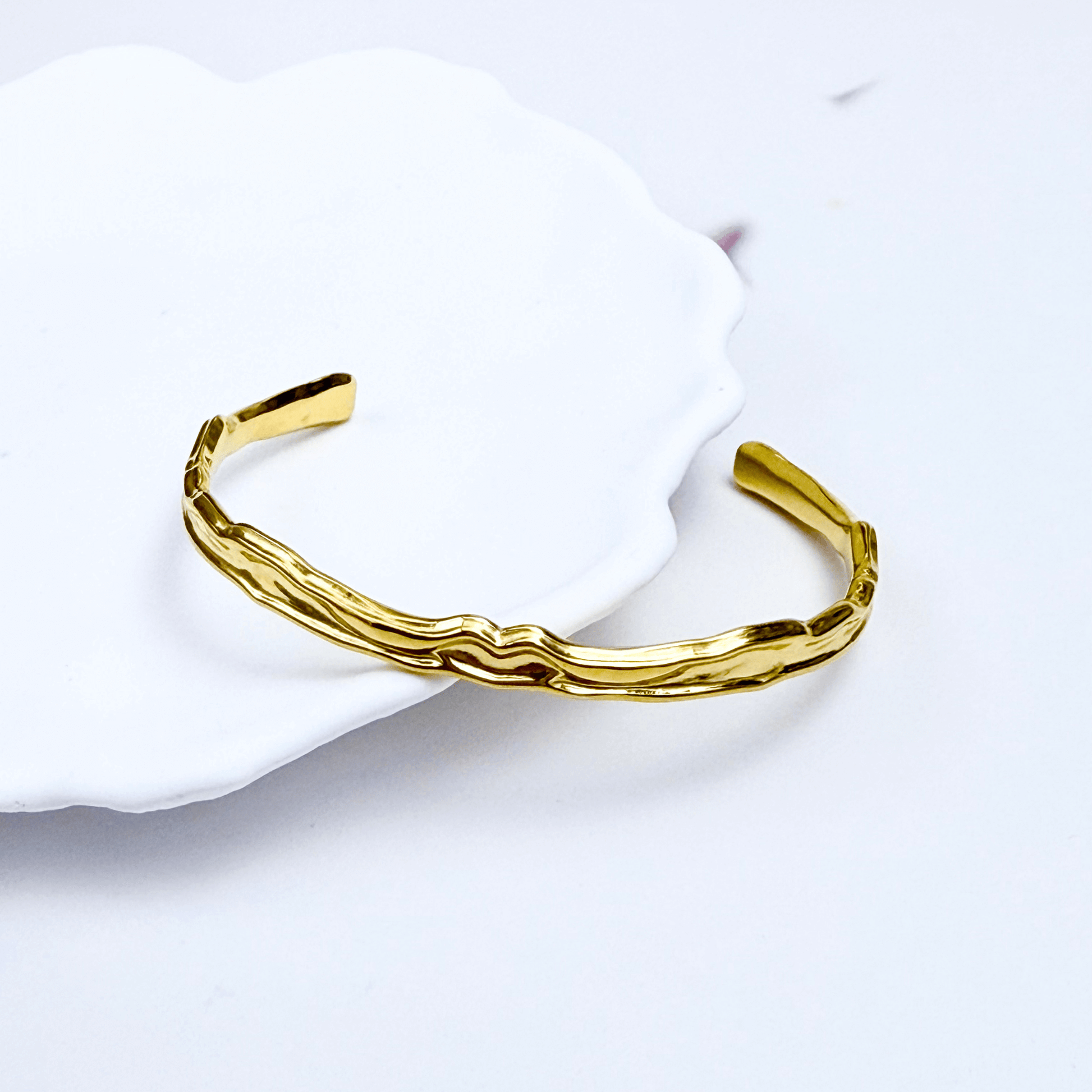 Gold textured cuff bracelet with molten, organic design.