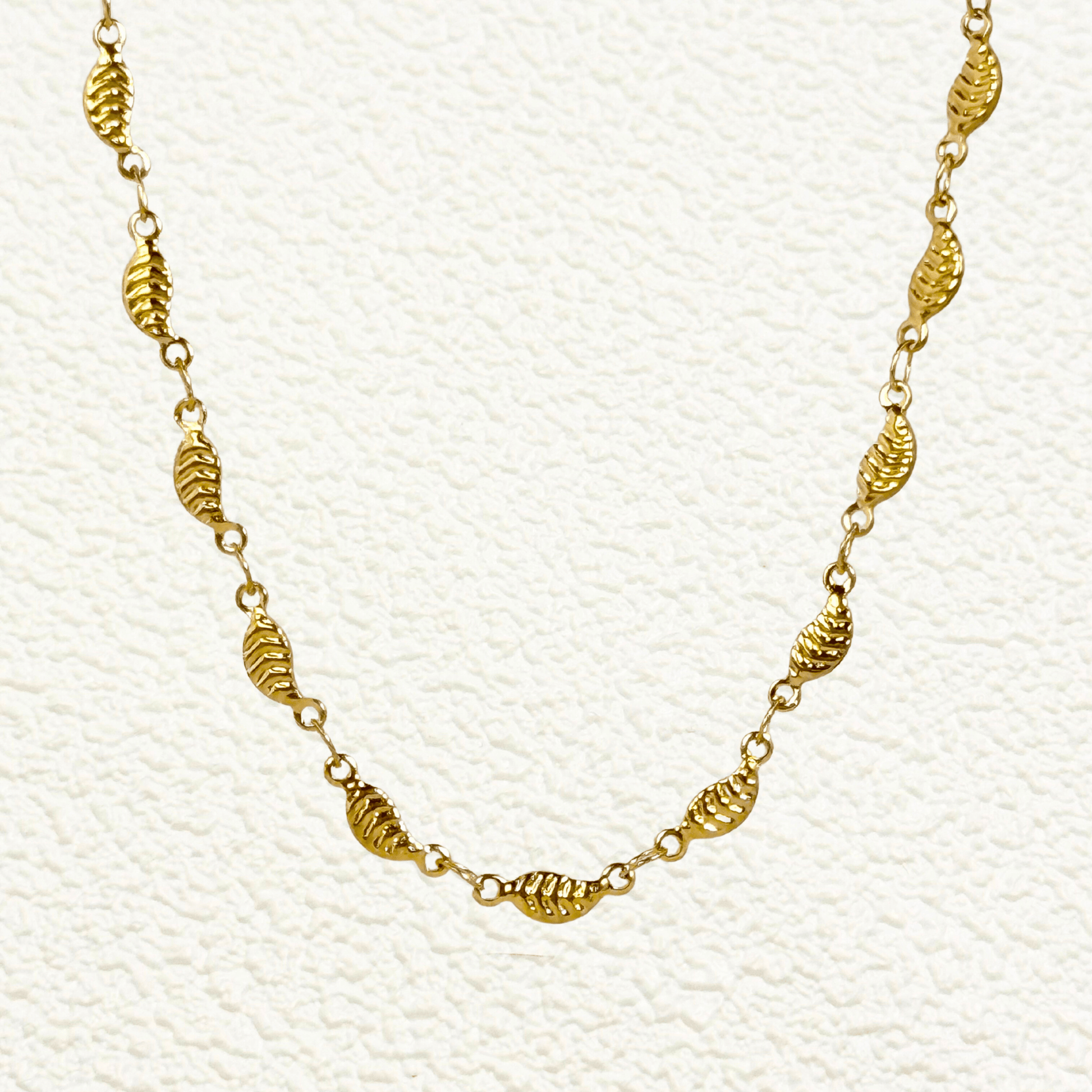 gold-toned leaf link chain made from stainless steel with delicate leaf-shaped links