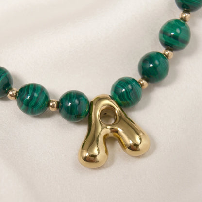 Malachite Gold Bubble Initial Necklace with polished green beads, gold spacers and a sculptural initial pendant.