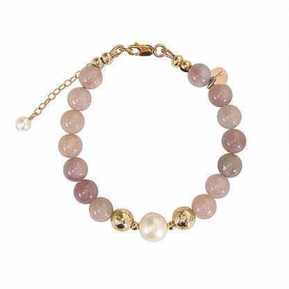 A beaded bracelet featuring mauve rose quartz, premium freshwater pearl, and stamped initial disc. 14k gold filled. MXW Jewellery