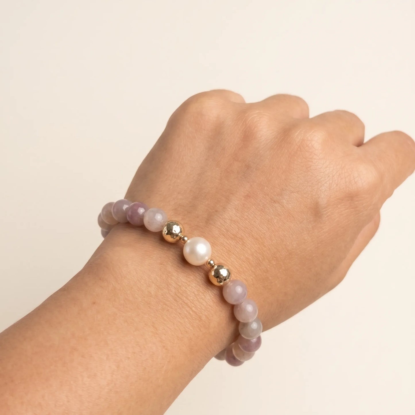 A beaded bracelet featuring mauve rose quartz, premium freshwater pearl, and stamped initial disc. 14k gold filled. MXW Jewellery