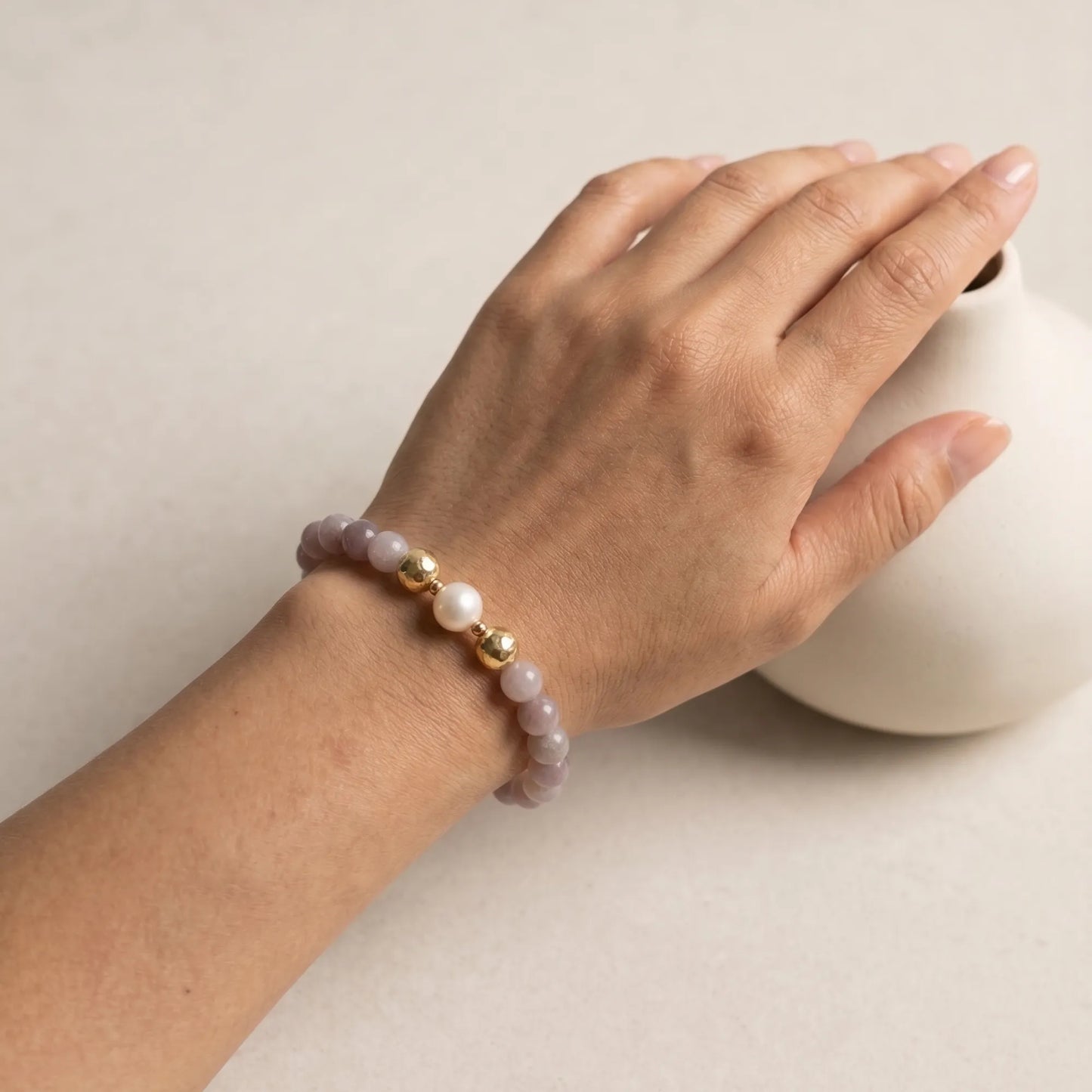 A beaded bracelet featuring mauve rose quartz, premium freshwater pearl, and stamped initial disc. 14k gold filled. MXW Jewellery