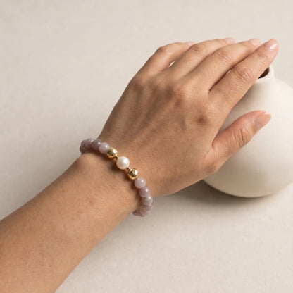 A beaded bracelet featuring mauve rose quartz, premium freshwater pearl, and stamped initial disc. 14k gold filled. MXW Jewellery