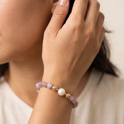 A beaded bracelet featuring mauve rose quartz, premium freshwater pearl, and stamped initial disc. 14k gold filled. MXW Jewellery