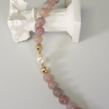 A beaded bracelet featuring mauve rose quartz, premium freshwater pearl, and stamped initial disc. 14k gold filled. MXW Jewellery