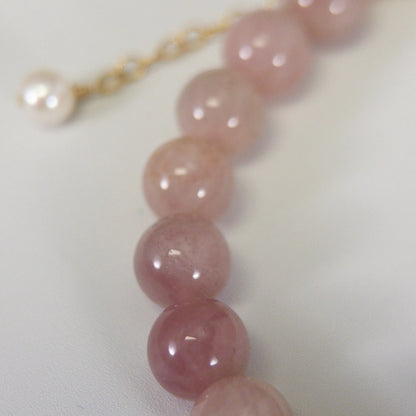 A beaded bracelet featuring mauve rose quartz, premium freshwater pearl, and stamped initial disc. 14k gold filled. MXW Jewellery