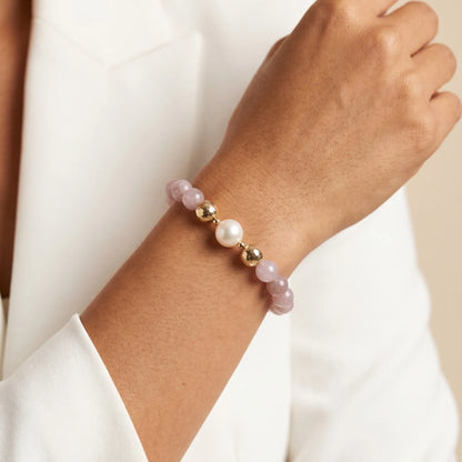 A beaded bracelet featuring mauve rose quartz, premium freshwater pearl, and stamped initial disc. 14k gold filled. MXW Jewellery
