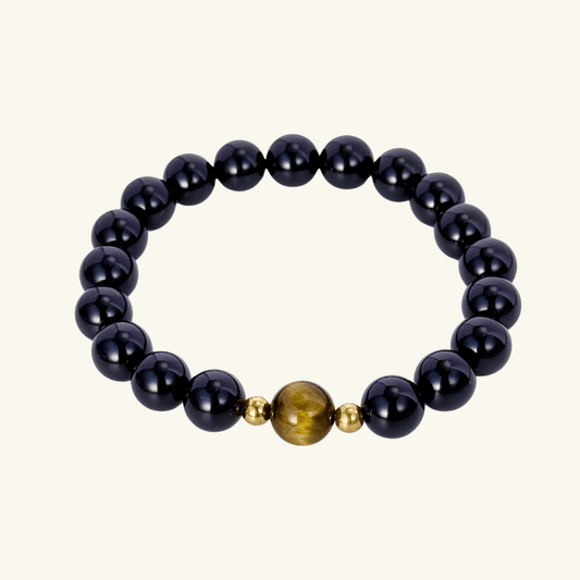 Men’s bracelet with polished black agate beads, single tiger’s eye gemstone, and gold accents on stretch cord.