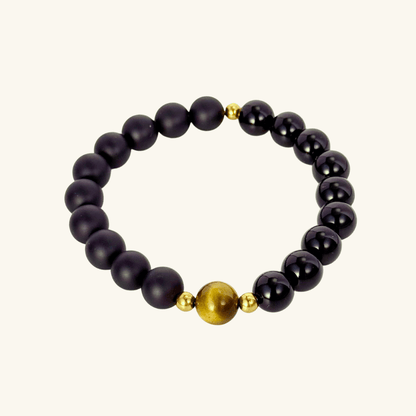 Men’s bracelet with polished black agate beads, single tiger’s eye gemstone, and gold accents on stretch cord.