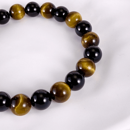 Handmade men’s bracelet with round black agate and tiger’s eye gemstone beads on elastic cord.