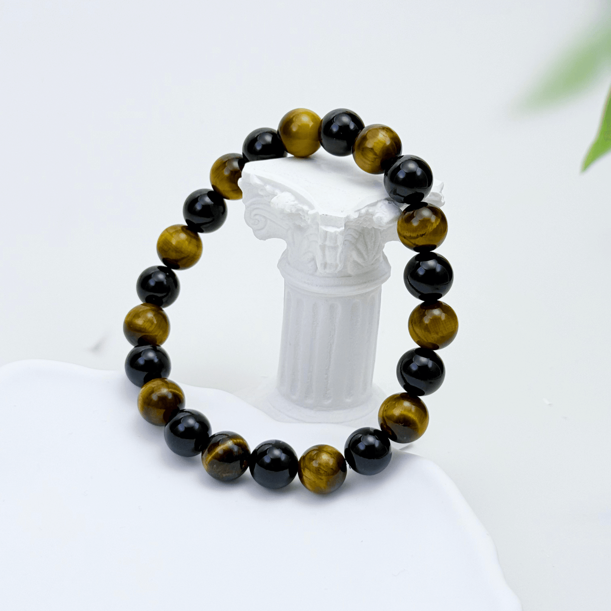 Handmade men’s bracelet with round black agate and tiger’s eye gemstone beads on elastic cord.