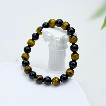 Handmade men’s bracelet with round black agate and tiger’s eye gemstone beads on elastic cord.