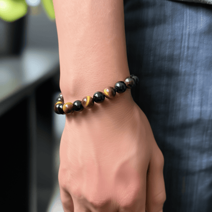 Handmade men’s bracelet with round black agate and tiger’s eye gemstone beads on elastic cord.