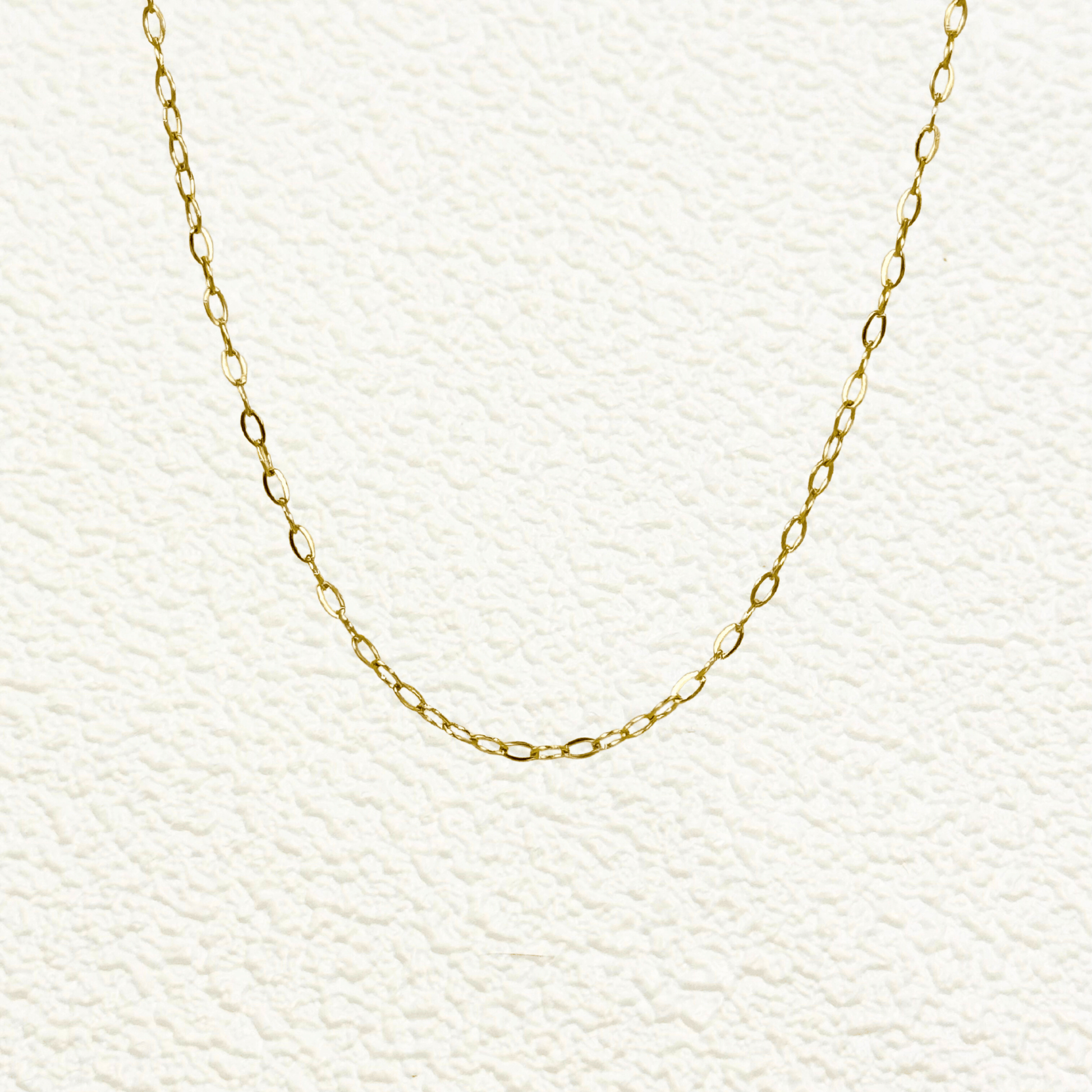 Mini paperclip link chain in 18K gold-plated stainless steel with fine elongated oval links, waterproof and tarnish-resistant, ideal for minimalist layering or adding custom charms