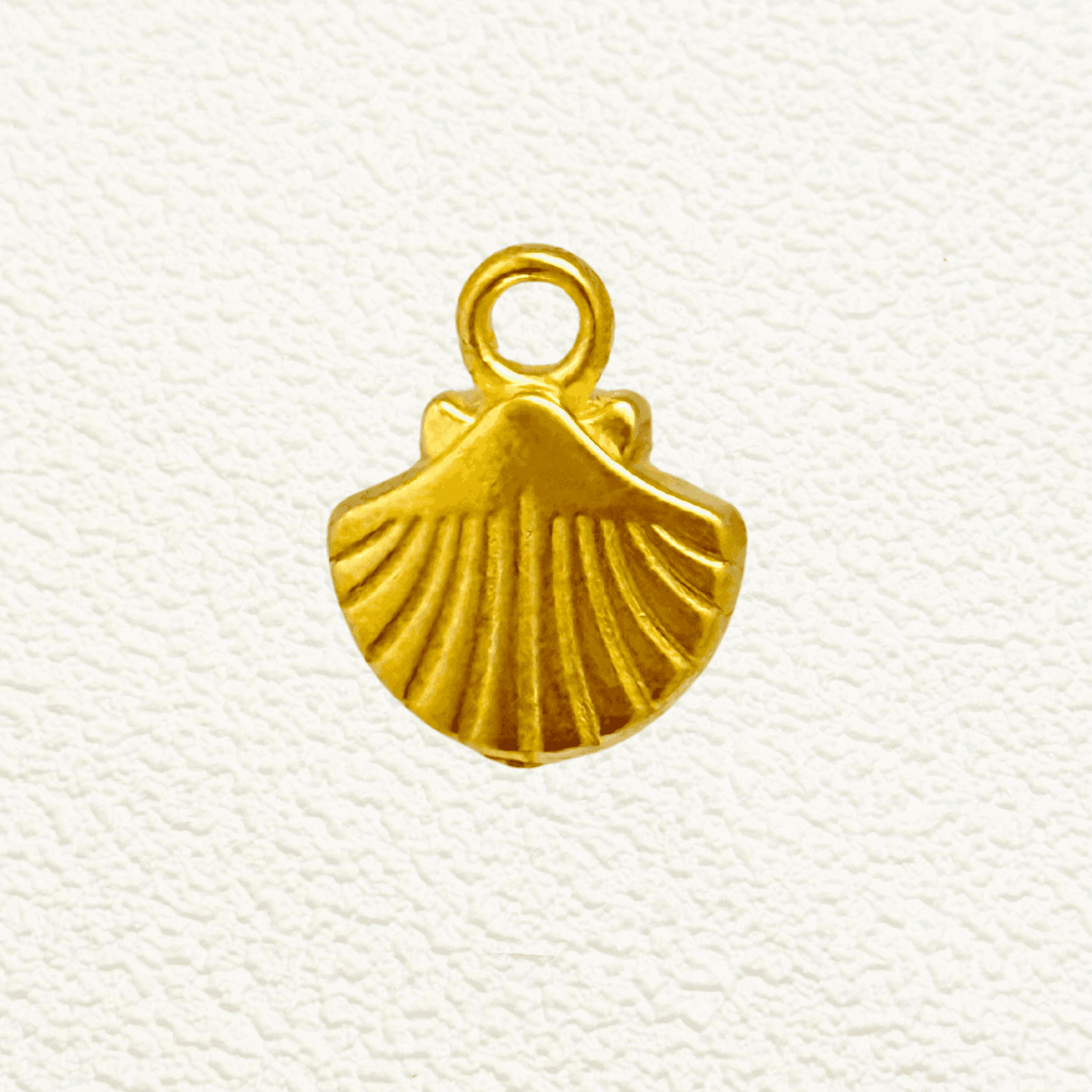 Gold scallop seashell charm with fine ridged texture, PVD gold plated finish