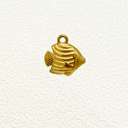Small gold tropical fish charm with textured detail and solid construction