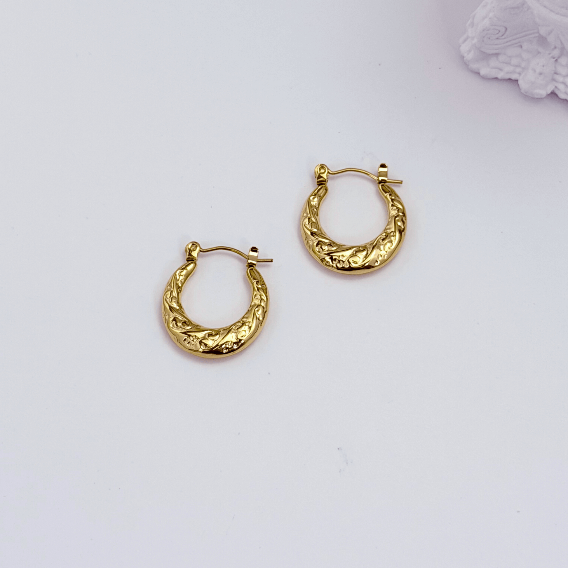 Molten Swirl Gold Hoop Earrings on white background